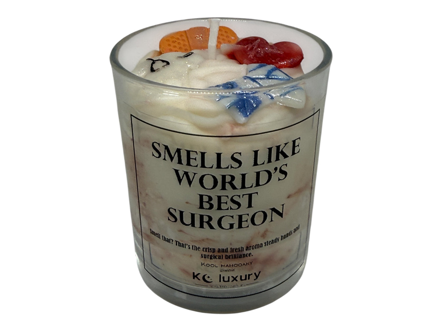 Handcrafted soy wax candle in a glass jar labeled "Smells Like World's Best Surgeon" with colorful decorative toppings.