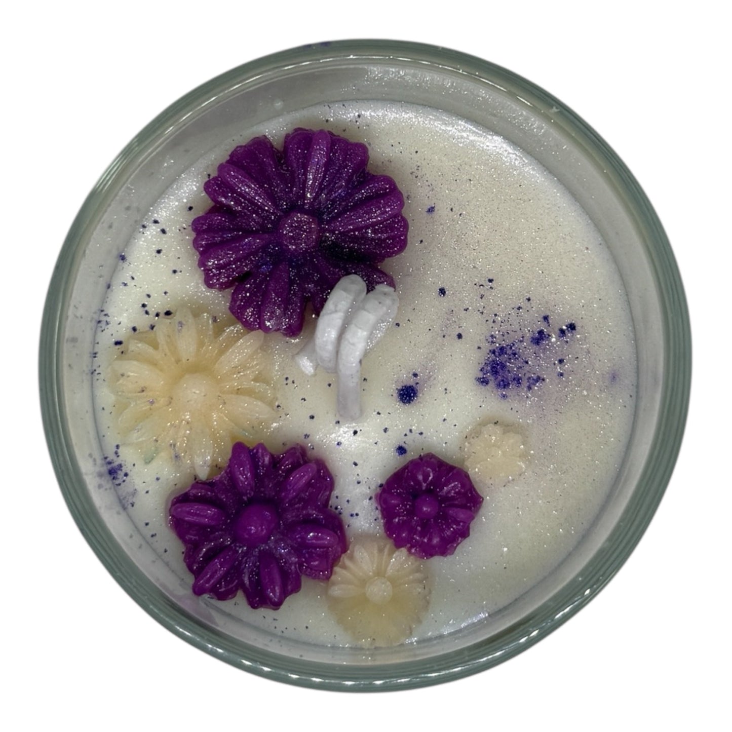 Top view of KC Luxury Garden Luxe candle with white wax, purple and cream flower-shaped accents, and purple floral dust from the Petal Luxe Collection