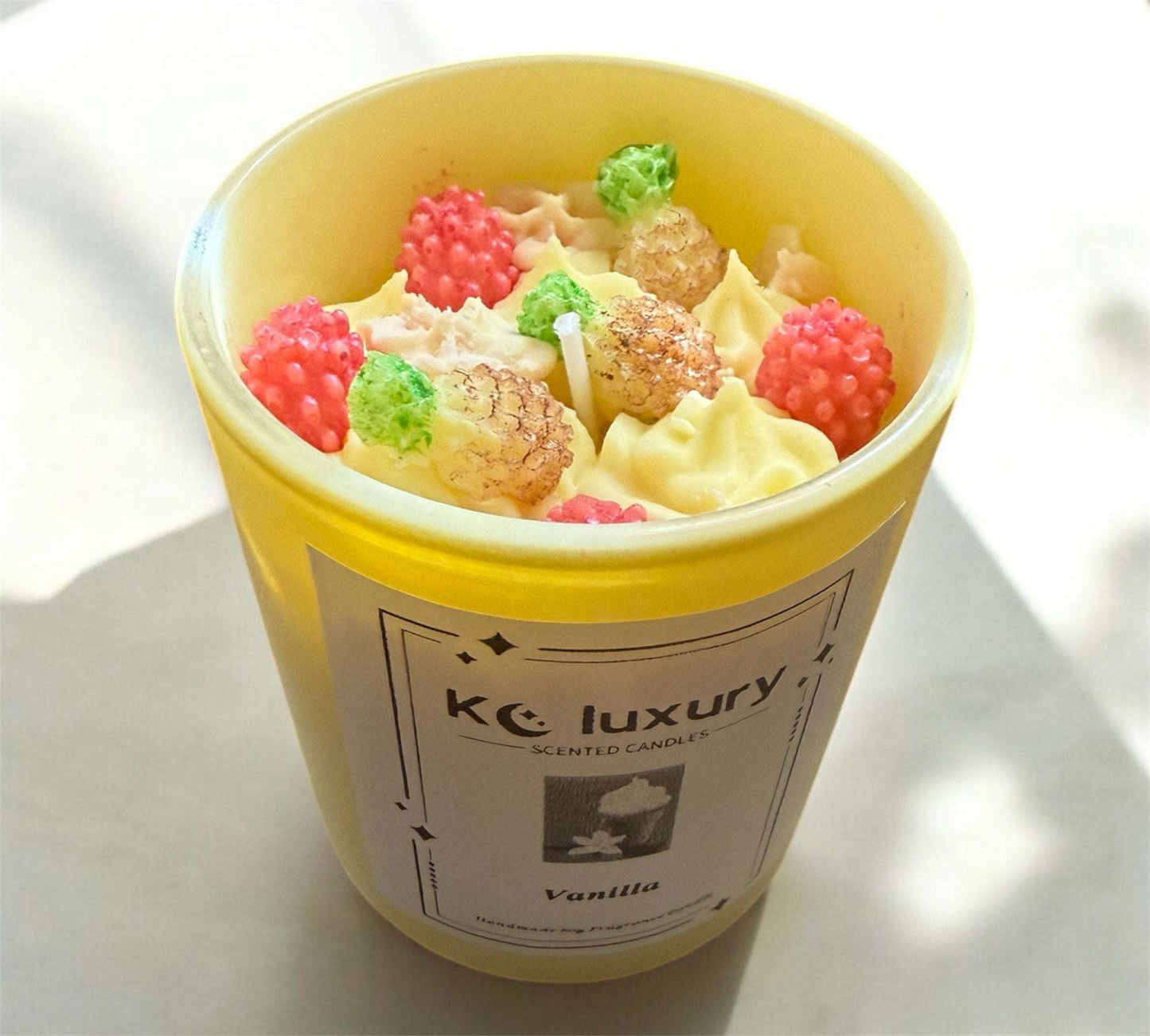 Tropical Bliss soy wax candle with pineapple and raspberry dessert design in yellow jar.