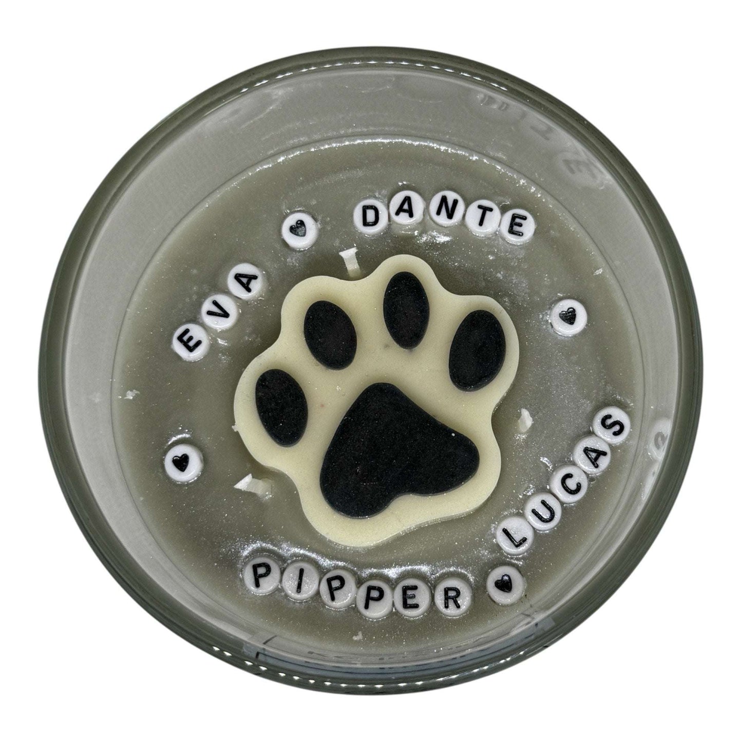 Custom pet candle with paw print and personalized pet names from The Pawfect Candle PawLuxe Collection