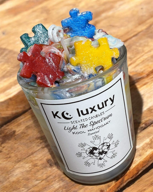 KC Luxury Light The Spectrum scented candle with colorful puzzle piece design for autism awareness.