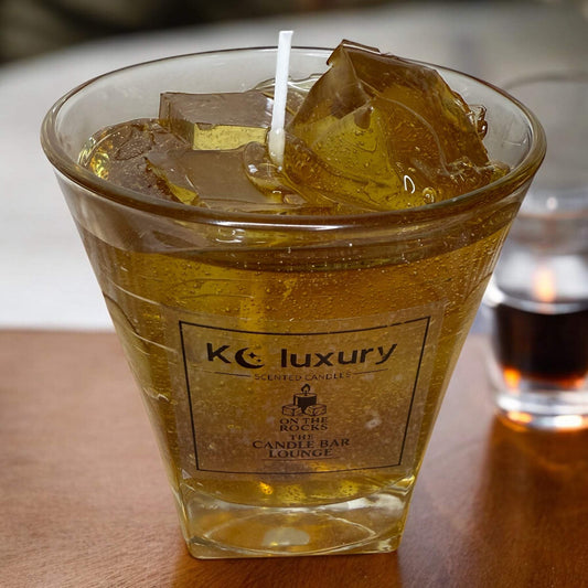 Handcrafted whiskey drink candle with realistic ice cube detailing by KC Luxury Candles.