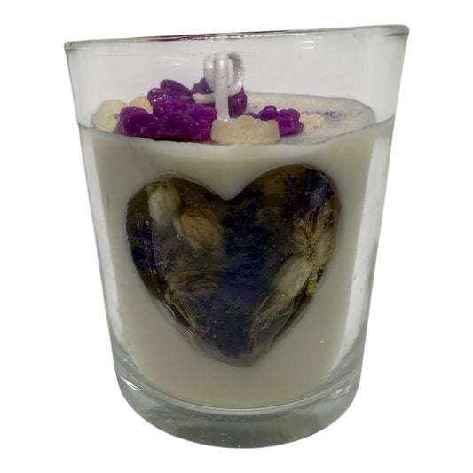 KC Luxury Garden Luxe white candle with heart-shaped jelly center filled with dried flowers and purple floral accents on top in clear glass
