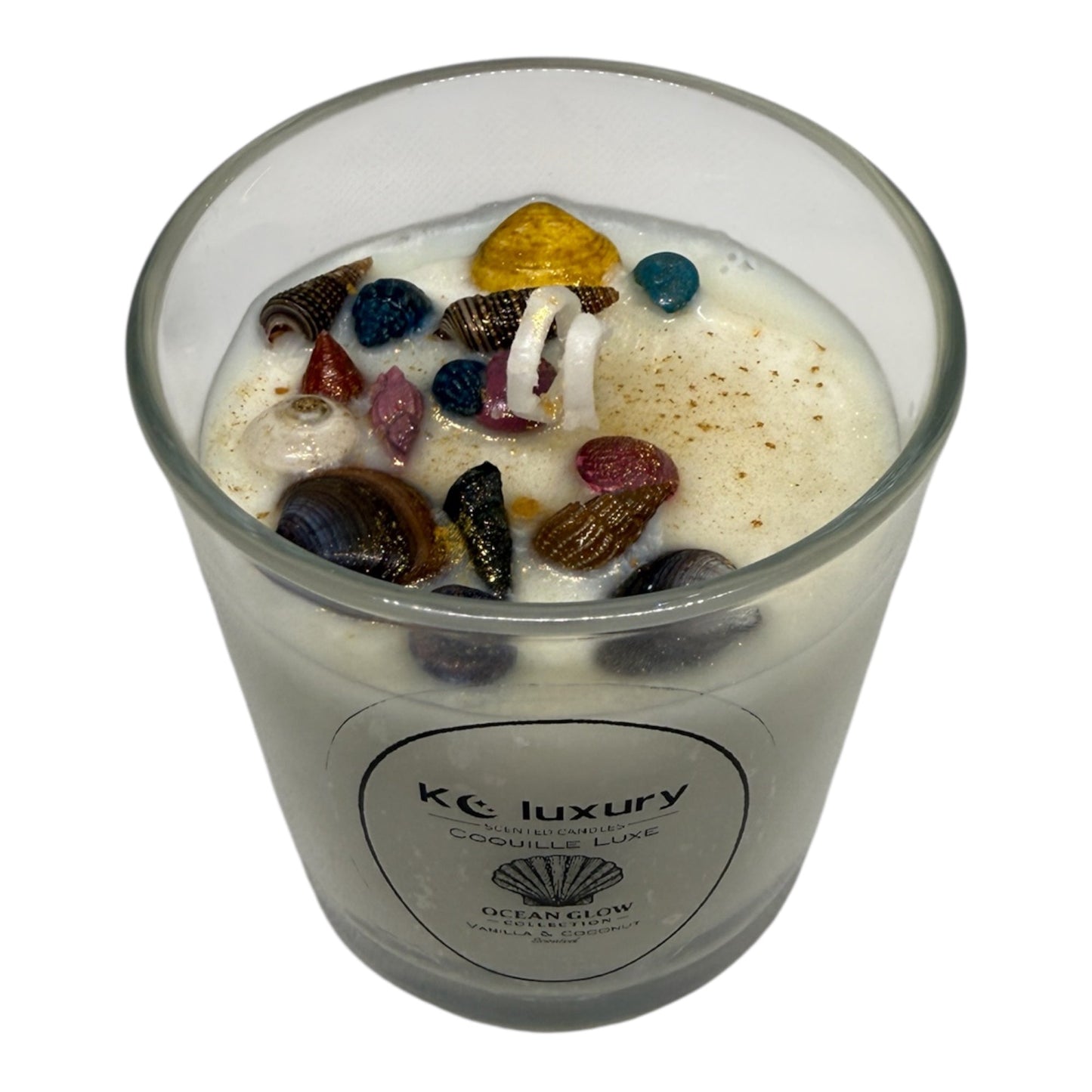 KC Luxury Coquille Luxe candle with white wax and colorful seashell accents from the Ocean Glow collection
