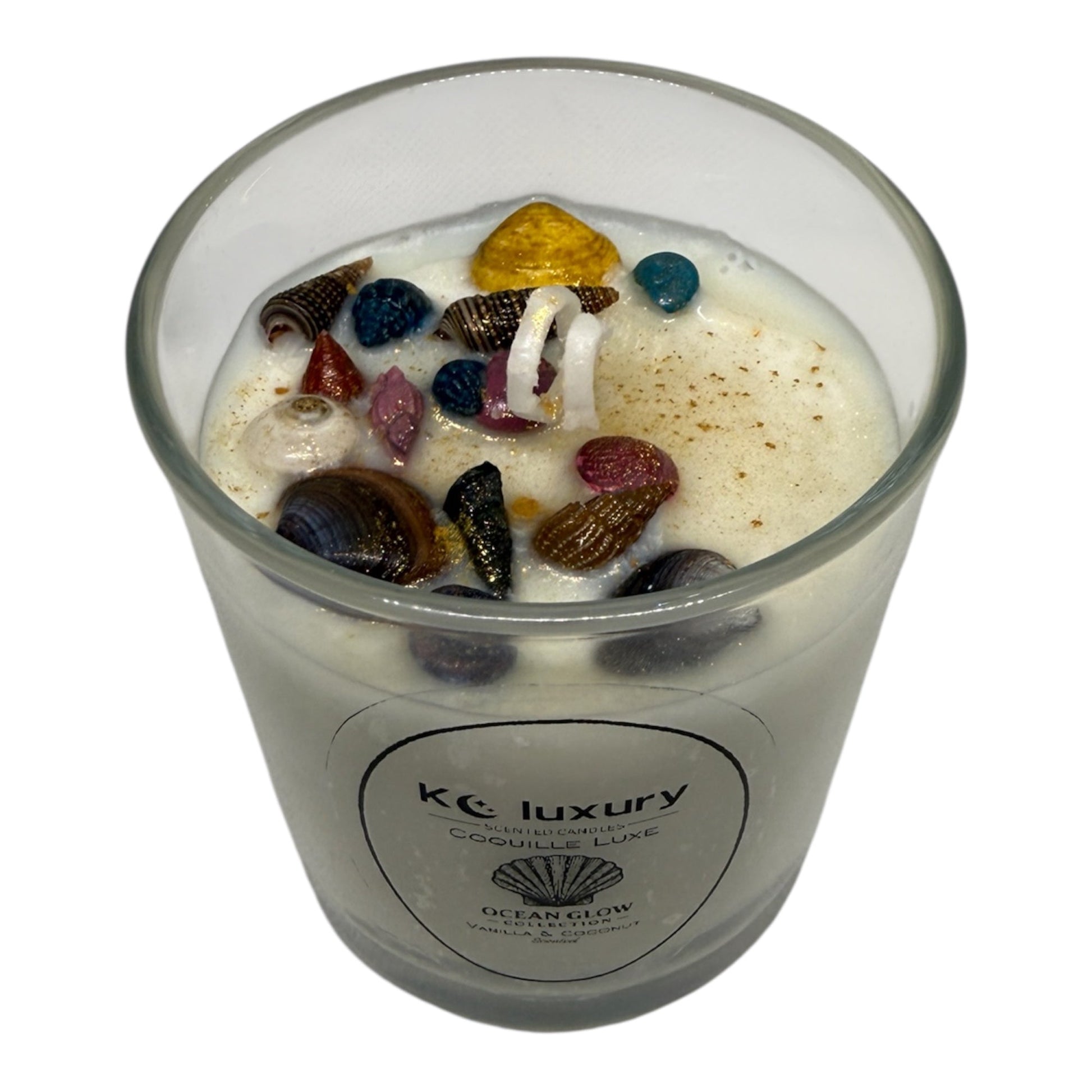 KC Luxury Coquille Luxe candle with white wax and colorful seashell accents from the Ocean Glow collection