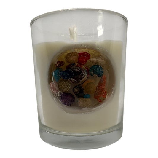 KC Luxury Coquille Luxe candle with clear jelly circle filled with colorful seashells in a glass container
