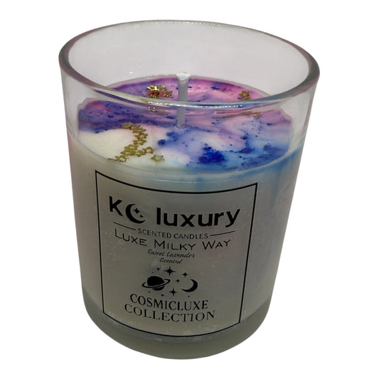 Luxe Milky Way Candle with purple, pink, and white swirls and gold constellation stars in a glass jar from KC Luxury CosmicLuxe Collection