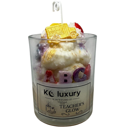 KC Luxury Teachers Glow scented candle with wax school bus, apple, and ABC letters in a glass jar