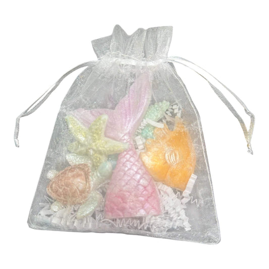 KC Luxe Wax Melts Collection in a decorative bag with assorted shaped artisan soy wax melts.