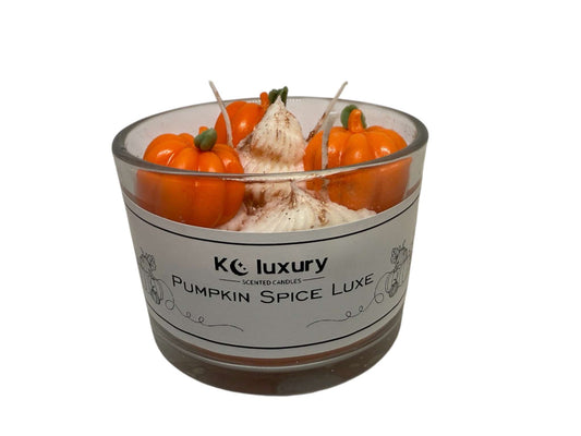 Pumpkin Spice Luxe Candle with pumpkin and spice decorations in clear glass jar, soy wax fall scented candle