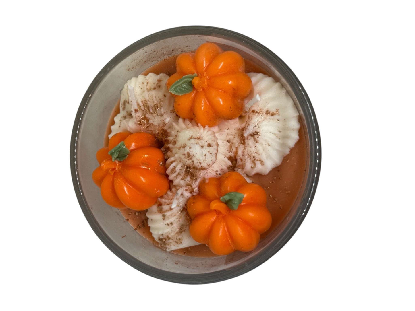 Top view of Pumpkin Spice Luxe Candle with decorative orange pumpkins and white wax swirls in glass container